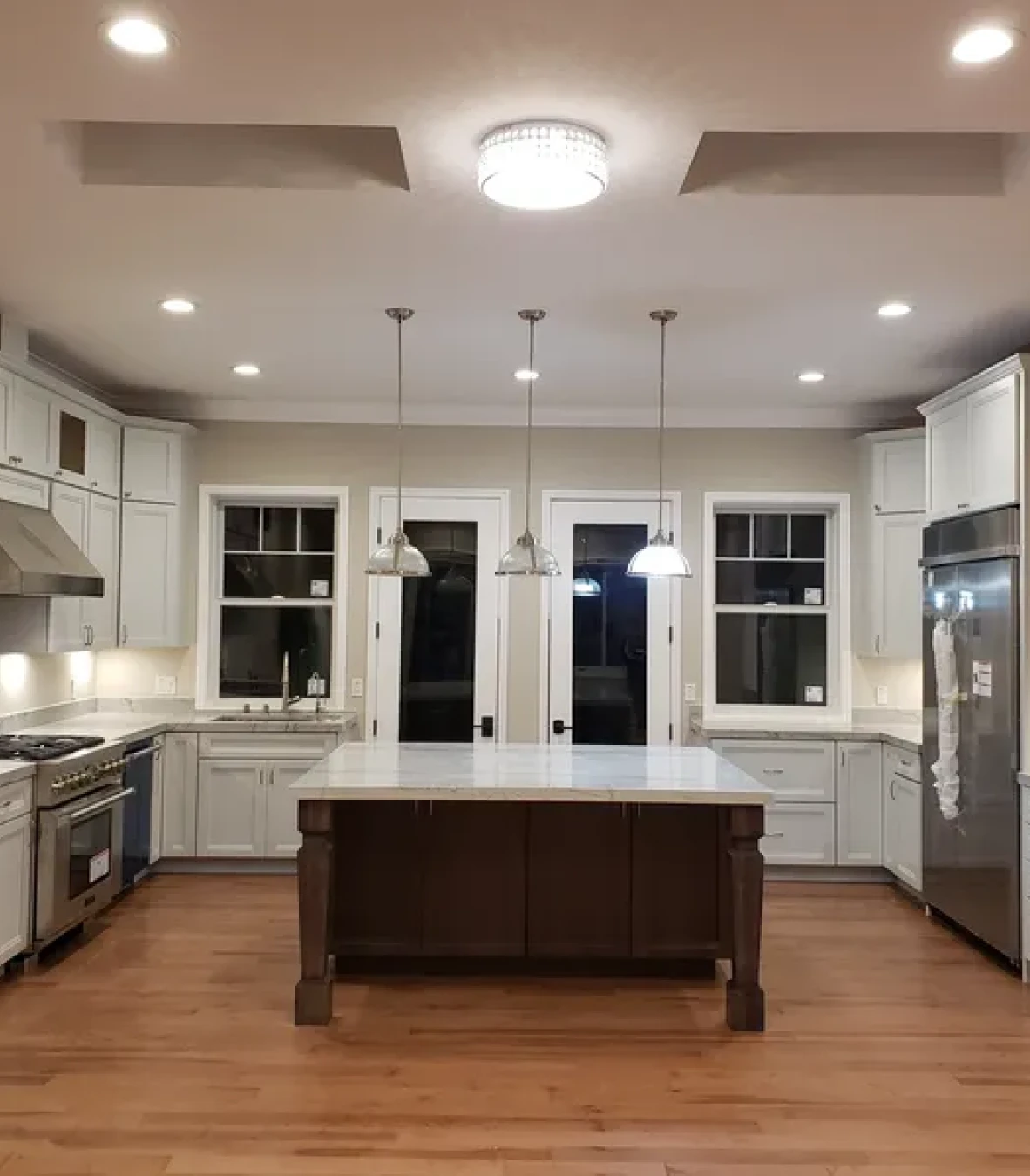 Spacious kitchen featuring wooden floors and cabinets
